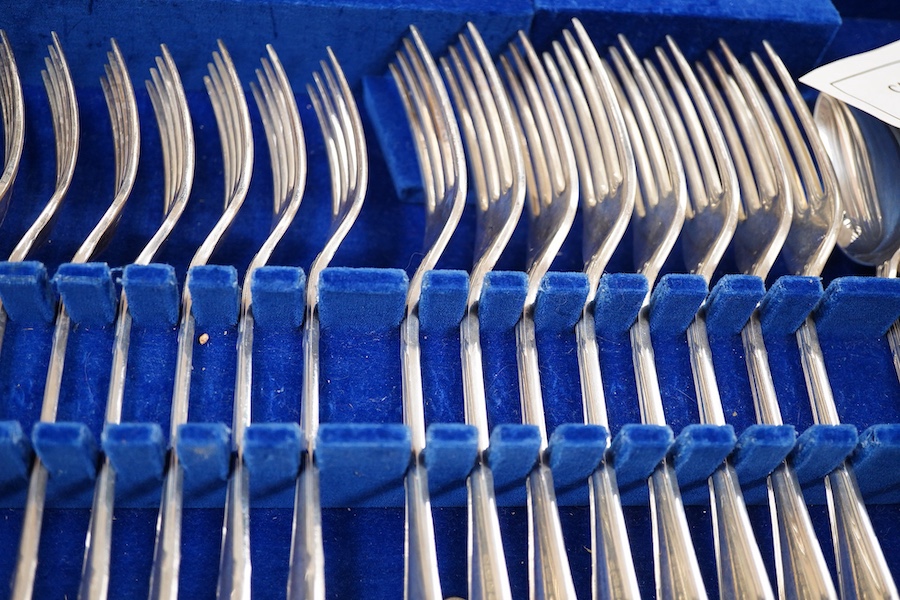 An Elizabeth II canteen of silver cutlery for eight, by Mappin & Webb, comprising table and dessert forks, dessert, soup and teaspoons, silver handled steel table and dessert knives two table or serving spoons and a pair